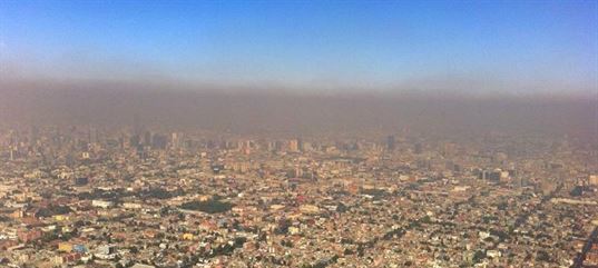The burning of organic materials, such as gasoline or coal, produces smog over cities around the world. While solvents are a tiny part of this very big problem, the use of low VOC solvents makes a difference. Photo: smog over Mexico City.