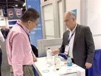 MicroCare COO Tom Tattersall demonstrates the Duraglide™ lubricant to an interested visitor