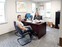 Kellie Labiniec and Heather Gombos enjoy a quiet moment of conversation in the new Human Resources offices at MicroCare