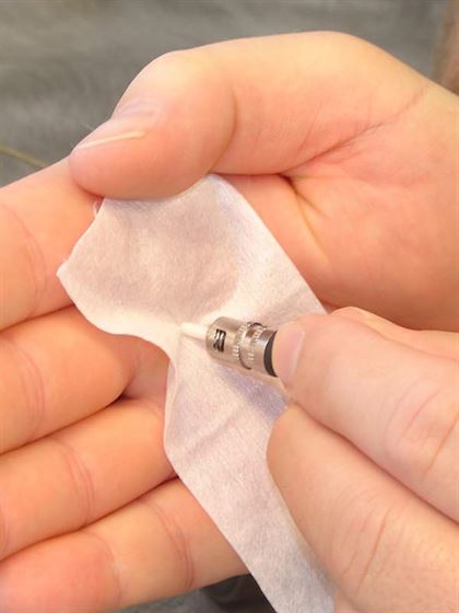 Using a damp wipe to clean a connector