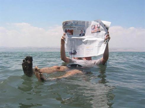 man floating in the dead sea